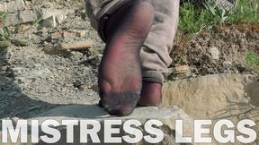 Jeans feet in black nylon socks on the seashore (MOV HD)