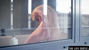 ”Petite blonde Lisa masturbates while having a sexy tub”