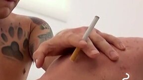 Seductive tatted hunks blows his cigar while he cums