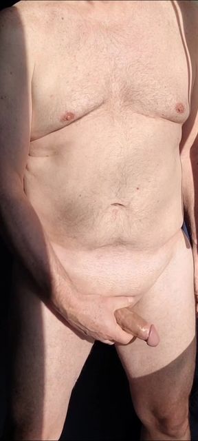 Old masturbator stroking shaved cock in the sun in slow motion