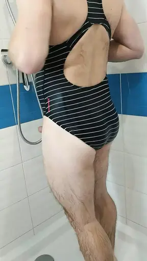 Boy wearing Speedo swimsuit and jerking