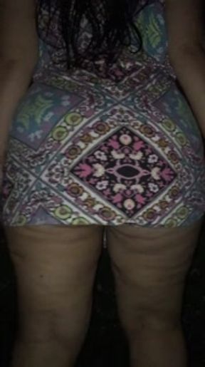 lifting up her dress on the street at night