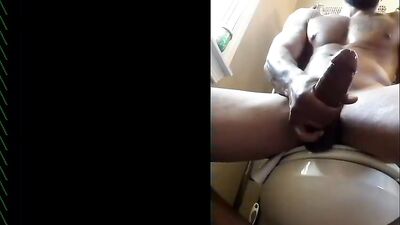 Black dude strokes his massive cock and jizzes a lot