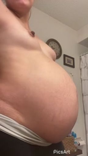 Pregnant milf rubs belly and then strips