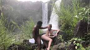 Big tits babe sucks a big black cock outdoor and fucks near Hawaiian waterfall
