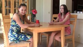 A strip Liars Dice game ends with both girls satisfying each other on the bed