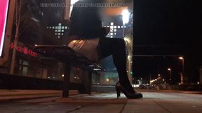 Crossdresser fixed on a bench at a tram station