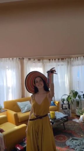 Woman in yellow dress with hat and sunglasses