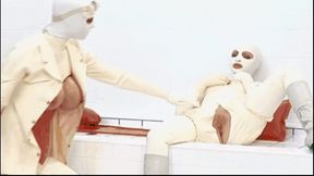 Two girls encased in white rubber catsuits - pussy fingered with latex gloves and warm piss emptied