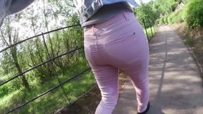 Pink jeans pissing outdoor