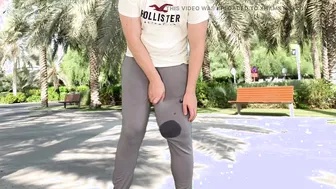 Twink with massive uncut cock bulges in grey sweatpants before huge hands-free cumshot outdoors