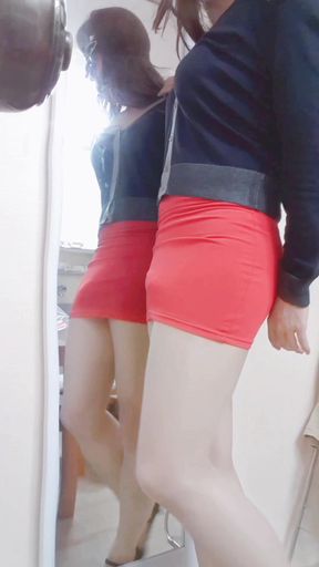Young asian crossdresser in tight red short skirt, pantyhose and highheels ready to go out