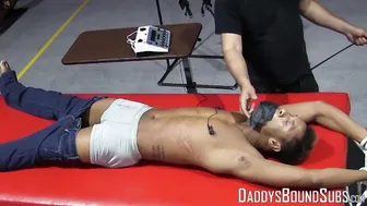 Kaden Roads flogs a bound captive before edging his cock