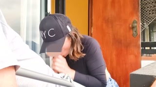 MILF gives blowjob on apartment balcony.