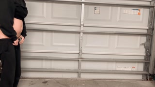 Hot college girl pees standing up in the garage at a party. Look how far she pissed