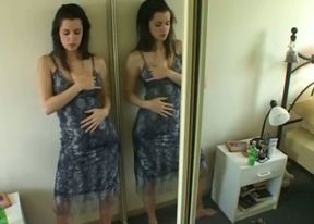 Seductive brunette chick masturbating standing in front of the mirror