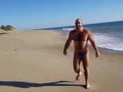 Beach walking in tiny bikini
