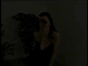 Brunette in lingerie and stockings dancing and stripping