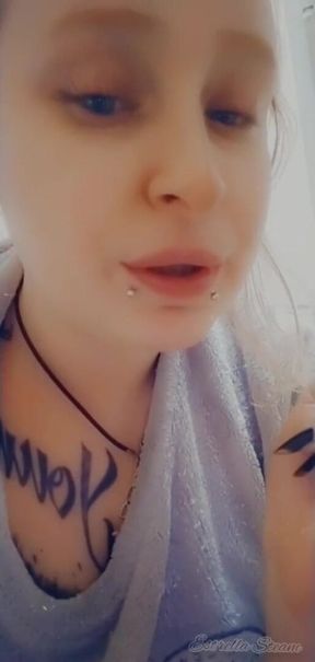 Girl with piercings smokes a cigarette