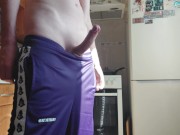 A Russian guy in sweatpants jerks off in the kitchen.