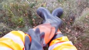 Worker In Hiviz Rain Gear And Rubber Boots