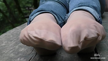 Jeans Feet In Nylon Socks In The Forest