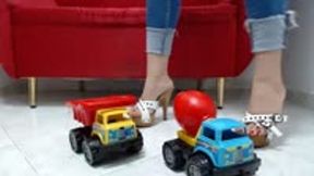 crushing a toy car in wooden sandals and Heels