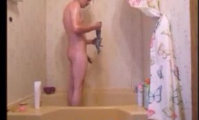 Nerdy sissy in pig tails strips & takes a shower playing with herself