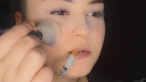 Anna smoking while doing makeup