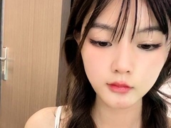 Amateur Asian babe sucks a lolly as she rubs her pussy