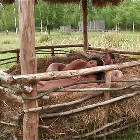 Hay proves to be the perfect cushion as the brunette gets her asshole stretched outdoors