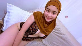 cute indonesia muslim woman in hijab is show off her leopard bra to her boyfriend.