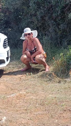 The Woman Pees on the Beach Parking Lot