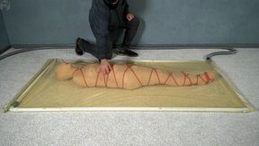 Mummification with bandages and rope bondage with ankle brace in a vacuum bed