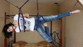 Ballgagged barefoot Ola in white t-shirt and blue jeans, suspended with violet hemp rope sideways, is tickled by camera man (HD MOV)