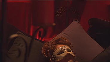 This masked brunette is chained to the bed and awaiting orders