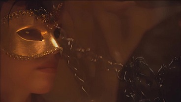 This masked brunette is chained to the bed and awaiting orders