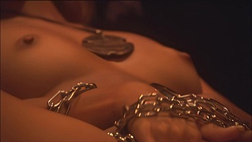 This masked brunette is chained to the bed and awaiting orders