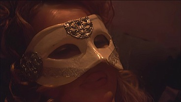 This masked brunette is chained to the bed and awaiting orders