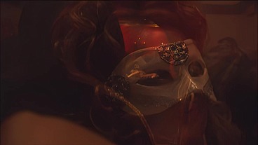 This masked brunette is chained to the bed and awaiting orders