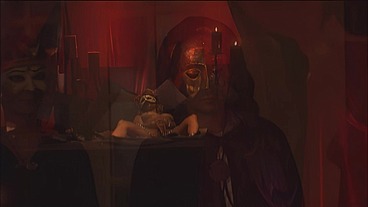 This masked brunette is chained to the bed and awaiting orders