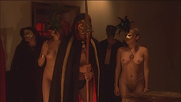 This masked brunette is chained to the bed and awaiting orders