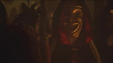 This masked brunette is chained to the bed and awaiting orders