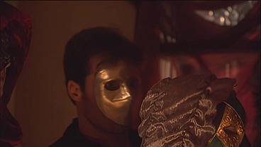 This masked brunette is chained to the bed and awaiting orders