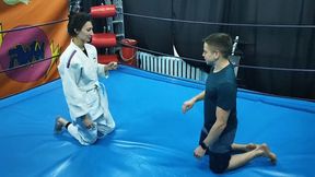Girl in a white gi wrestles