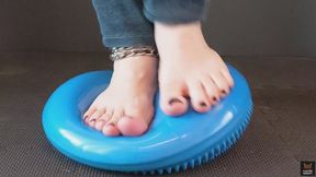 Barefeet blue cushion trampling