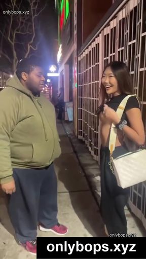 Two people talking on the street