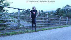 crossdressed outdoors on a motorway bridge