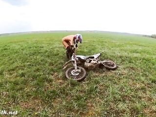 Naked woman riding a Dirt Bike