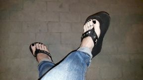 a crossdresser on a night walk walks around and tempts with his beautiful feet